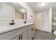 The bathroom features a double sink vanity with modern faucets and a shower with shelving at 7322 Groveland Farms Rd, Groveland, FL 34736