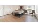 This bedroom features wood-look floors, a queen bed, and a window providing natural light at 7322 Groveland Farms Rd, Groveland, FL 34736