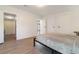 This bedroom boasts wood-look floors, a queen bed, and an ensuite bathroom with shower at 7322 Groveland Farms Rd, Groveland, FL 34736