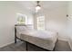 This bedroom features one bed, a ceiling fan, and two windows providing natural light at 7322 Groveland Farms Rd, Groveland, FL 34736