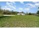 View of a single-Gathering home with a spacious yard, showcasing its potential for outdoor activities and relaxation at 7322 Groveland Farms Rd, Groveland, FL 34736