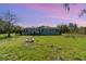 Charming blue single-Gathering home with a well-maintained lawn and a welcoming fire pit at 7322 Groveland Farms Rd, Groveland, FL 34736