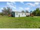 Exterior view showcasing the home's wood deck, and serene surroundings at 7322 Groveland Farms Rd, Groveland, FL 34736