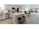 Charming kitchen featuring stainless steel appliances, white cabinets, and barstool seating at 7322 Groveland Farms Rd, Groveland, FL 34736