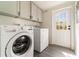 The laundry room features new appliances, wood-look floors and ample cabinet space at 7322 Groveland Farms Rd, Groveland, FL 34736