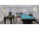 A modern game room is shown with a pool table, foosball table, and bar at 7325 Burnway Dr, Orlando, FL 32819