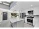Bright kitchen with a large island, stainless steel appliances, and modern backsplash at 7325 Burnway Dr, Orlando, FL 32819