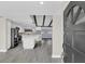 Modern kitchen featuring white cabinets, stainless steel appliances, a center island, and updated gray flooring at 7325 Burnway Dr, Orlando, FL 32819