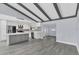 Modern kitchen with stainless steel appliances, a gray island, and wood-look flooring at 7325 Burnway Dr, Orlando, FL 32819