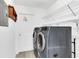 A laundry room with a modern washer and dryer, wire shelving, and white walls at 7325 Burnway Dr, Orlando, FL 32819
