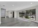 Open living space features a large window, gray floors, and access to other rooms for easy flow at 7325 Burnway Dr, Orlando, FL 32819