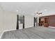 An open living room featuring vinyl floors, a ceiling fan, and a built-in wooden cabinet at 7325 Burnway Dr, Orlando, FL 32819