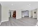 Spacious living area with gray flooring and open access to other rooms, perfect for entertaining and modern living at 7325 Burnway Dr, Orlando, FL 32819