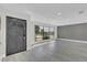 Open concept living area with gray flooring, large window, and modern front door provides lots of natural light at 7325 Burnway Dr, Orlando, FL 32819