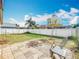 Large backyard with well maintained lawn, white fencing, and lounge chairs at 734 Adidas Rd, Winter Springs, FL 32708