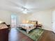 Spacious bedroom featuring a ceiling fan, wood floors, sliding door access to a patio, and ample natural light at 734 Adidas Rd, Winter Springs, FL 32708