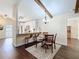 Bright dining area featuring hardwood floors, seamlessly connects to the kitchen with granite countertop and breakfast bar at 734 Adidas Rd, Winter Springs, FL 32708