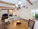 Charming dining room features wood beams, hardwood floors, and seamlessly connects to the living room at 734 Adidas Rd, Winter Springs, FL 32708