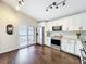 Modern kitchen with white cabinets, stainless steel appliances, granite counters and hardwood floors throughout at 734 Adidas Rd, Winter Springs, FL 32708