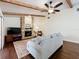 Inviting living room with stone fireplace, wood beams, and hardwood floors is perfect for relaxing and entertaining at 734 Adidas Rd, Winter Springs, FL 32708