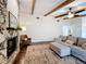 Comfortable living room featuring a stone fireplace, exposed wood beams, and an inviting seating area at 734 Adidas Rd, Winter Springs, FL 32708
