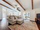 Bright living room featuring exposed wood beams and an open layout that connects to the kitchen at 734 Adidas Rd, Winter Springs, FL 32708