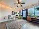 Sun room with bright lighting, tile floors, and decorative plants, with furniture and vintage mirrors at 734 Adidas Rd, Winter Springs, FL 32708