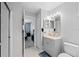Bright bathroom featuring a single sink vanity, tiled floor, and a view into the bedroom area at 877 Scrub Jay Way, Davenport, FL 33896