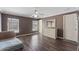 Spacious bedroom with hardwood floors, large windows, and an ensuite bathroom at 877 Scrub Jay Way, Davenport, FL 33896
