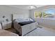 Comfortable bedroom featuring a white bed frame, neutral walls, and a large window that lets in plenty of natural light at 877 Scrub Jay Way, Davenport, FL 33896