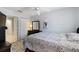 Cozy bedroom featuring a patterned bedspread, ceiling fan, dark wood dresser, and neutral walls at 877 Scrub Jay Way, Davenport, FL 33896