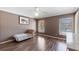 Bedroom features hardwood floors, a window with natural light, and neutral paint at 877 Scrub Jay Way, Davenport, FL 33896