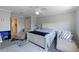 Spacious bedroom with a white bed frame, a ceiling fan, and two chaise lounges on a soft rug, creating a relaxing retreat at 877 Scrub Jay Way, Davenport, FL 33896