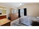 Well-lit bedroom with carpeting, vaulted ceilings, and an ensuite bathroom at 877 Scrub Jay Way, Davenport, FL 33896