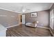Large bedroom with hardwood floors, neutral paint and large windows providing natural light at 877 Scrub Jay Way, Davenport, FL 33896