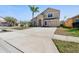 Exterior elevation of a two-story home with an attached garage, well-kept lawn, and a classic architectural style at 877 Scrub Jay Way, Davenport, FL 33896