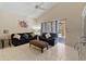Bright living room with tile floors, vaulted ceilings and sliding glass doors to the pool area at 877 Scrub Jay Way, Davenport, FL 33896