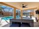 Inviting screened-in patio with a dining table, outdoor seating, and views of the sparkling swimming pool and lush landscaping at 877 Scrub Jay Way, Davenport, FL 33896
