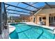 Gorgeous pool with a spa surrounded by a screened-in enclosure, and a covered patio, creating a perfect outdoor oasis at 877 Scrub Jay Way, Davenport, FL 33896