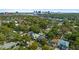 City skyline in the distance from an aerial view of a residential neighborhood with mature trees at 900 Golfview St, Orlando, FL 32804