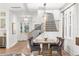 Dining room with stylish chairs, staircase access, hardwood floors, and modern lighting at 900 Golfview St, Orlando, FL 32804