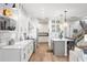 Modern kitchen with white cabinetry, a kitchen island, stainless steel appliances, and hardwood floors at 900 Golfview St, Orlando, FL 32804