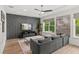 Stylish living room showcasing a decorative accent wall, a comfortable couch, and hardwood floors at 900 Golfview St, Orlando, FL 32804