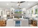 Spacious living room with fireplace, large TV, ceiling fans, and white draperies at 900 Golfview St, Orlando, FL 32804
