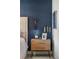 Close-up of a stylish wooden nightstand with a lamp, plants, and decor, adding warmth to the bedroom at 900 Golfview St, Orlando, FL 32804