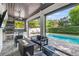 Outdoor living space featuring a kitchen, fire pit, comfortable seating, and a view of the pool at 900 Golfview St, Orlando, FL 32804