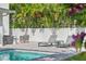 Relaxing poolside area with lounge chairs, side tables, and tropical landscaping at 900 Golfview St, Orlando, FL 32804