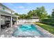 Backyard oasis with a sparkling pool, lounge chairs, a covered patio, and lush tropical landscaping at 900 Golfview St, Orlando, FL 32804