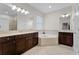 The primary bathroom features a soaking tub, dual vanities, and elegant fixtures for a spa-like experience at 10078 Greenshire Way, Orlando, FL 32827