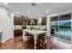 Modern kitchen features dark cabinets and stainless appliances, next to the outdoor pool at 10078 Greenshire Way, Orlando, FL 32827